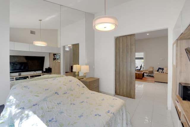 bedroom featuring high vaulted ceiling and light tile patterned floors