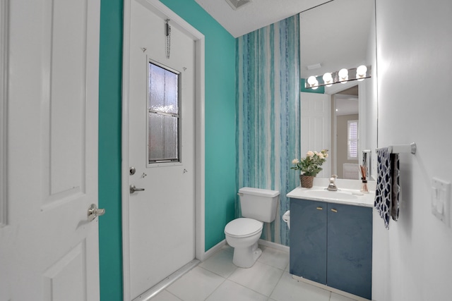 bathroom featuring vanity, toilet, and tile patterned flooring