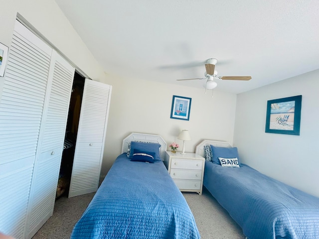 carpeted bedroom with a closet and ceiling fan