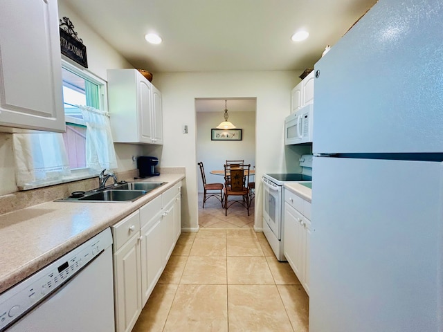 kitchen with white appliances, white cabinetry, sink, and decorative light fixtures