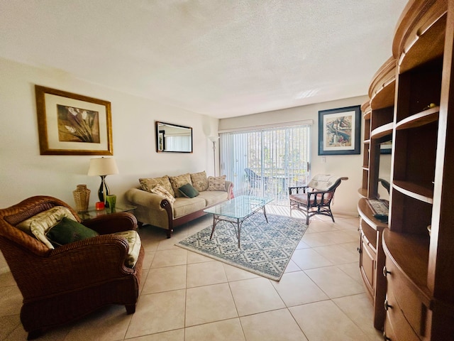 living room featuring a textured ceiling and light tile patterned floors