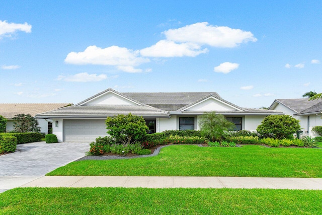 ranch-style home featuring a front lawn and a garage