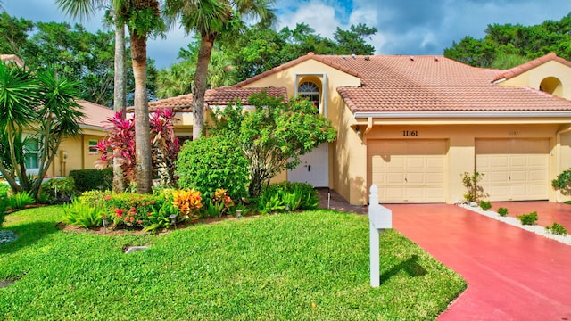 mediterranean / spanish-style house with a front yard and a garage