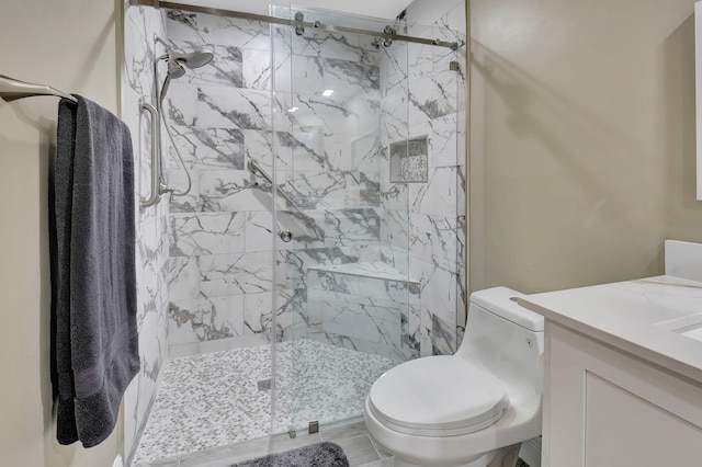 bathroom featuring vanity, toilet, and walk in shower