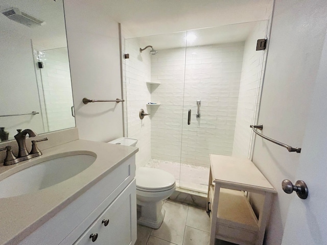 bathroom with vanity, tile patterned flooring, toilet, and an enclosed shower