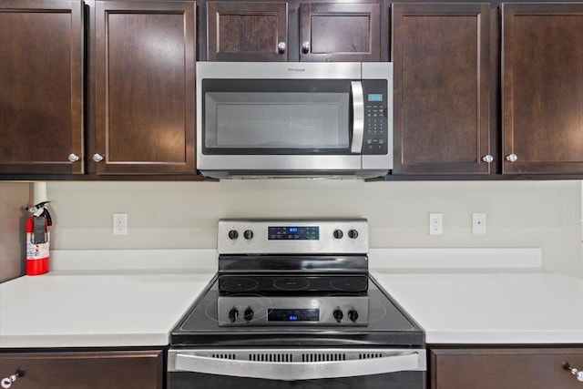 kitchen featuring stainless steel appliances and dark brown cabinets