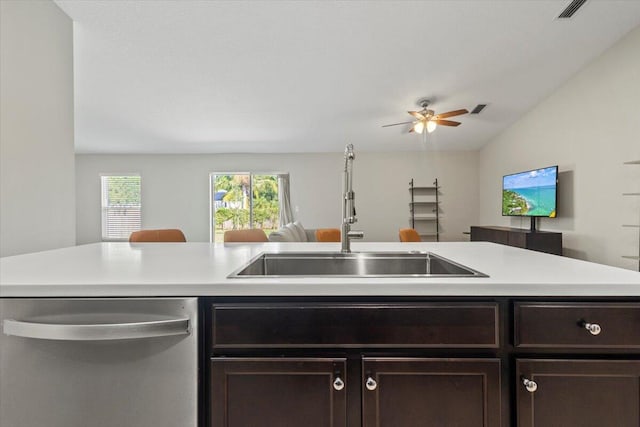 kitchen with sink, dark brown cabinets, ceiling fan, lofted ceiling, and stainless steel dishwasher