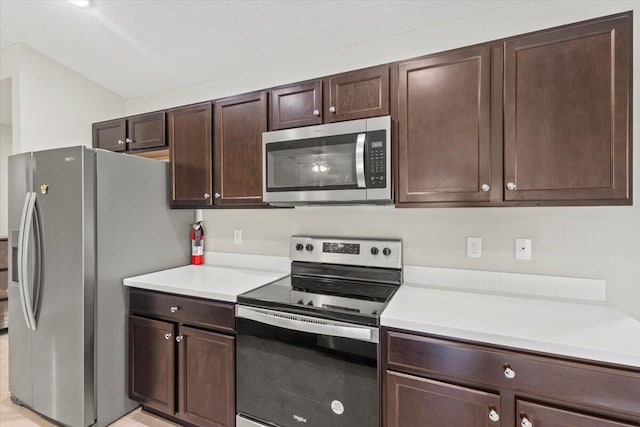 kitchen featuring dark brown cabinets and stainless steel appliances