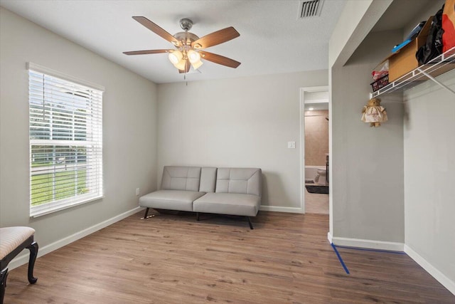 sitting room featuring hardwood / wood-style floors and ceiling fan