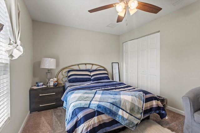 carpeted bedroom featuring a closet, ceiling fan, and multiple windows