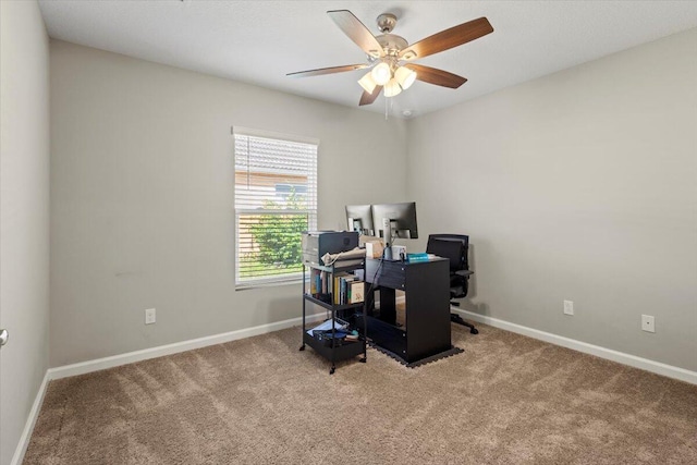 carpeted office space with ceiling fan