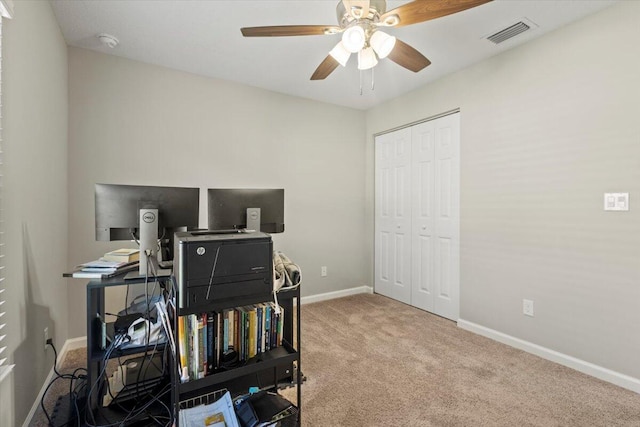 carpeted home office with ceiling fan