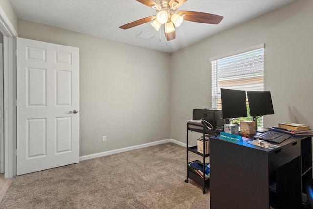 office space featuring light carpet and ceiling fan