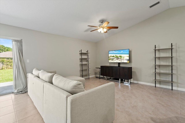 living room featuring ceiling fan, light tile patterned flooring, and lofted ceiling