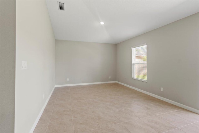 spare room featuring light tile patterned flooring