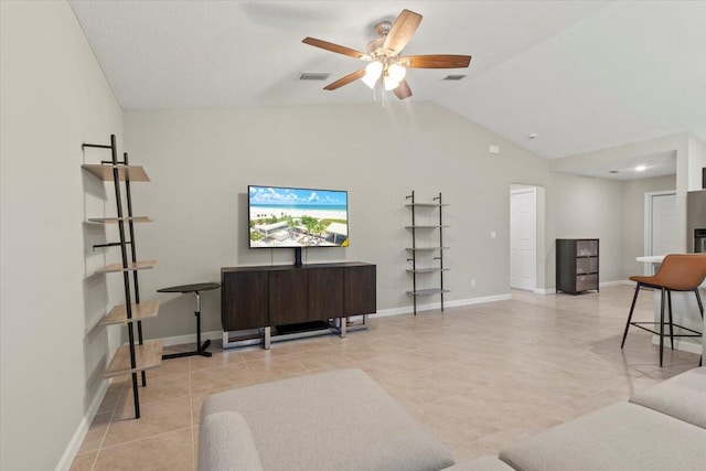 living room with lofted ceiling, light tile patterned floors, and ceiling fan