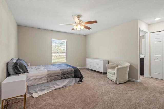 carpeted bedroom featuring connected bathroom and ceiling fan