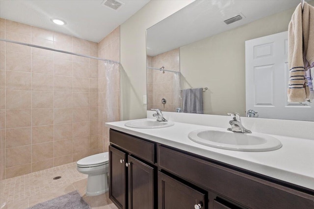 bathroom with vanity, a shower with curtain, toilet, and tile patterned floors