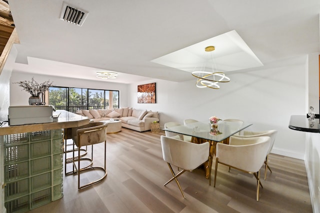 dining room featuring a notable chandelier and hardwood / wood-style floors