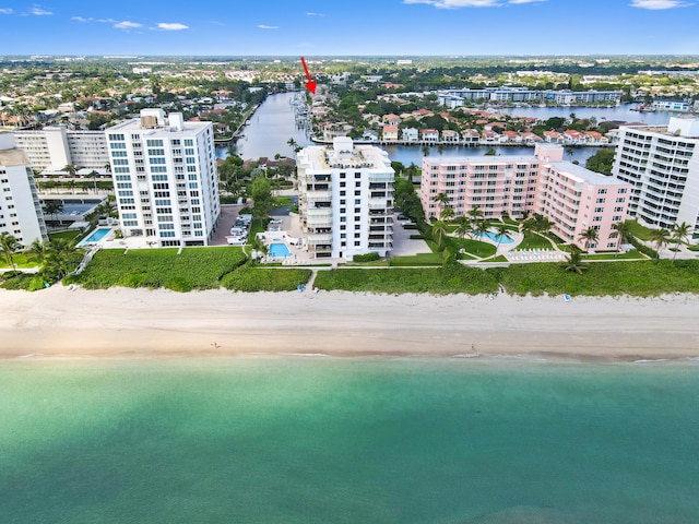 drone / aerial view with a water view and a beach view