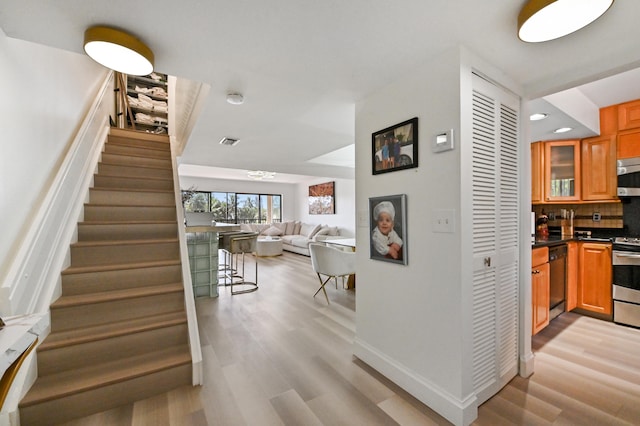 stairs with hardwood / wood-style flooring