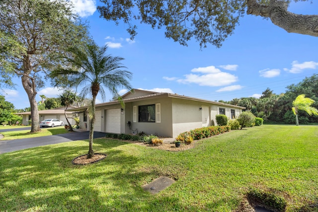 view of front of property with a garage and a front lawn