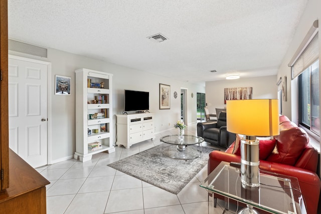 tiled living room with a textured ceiling