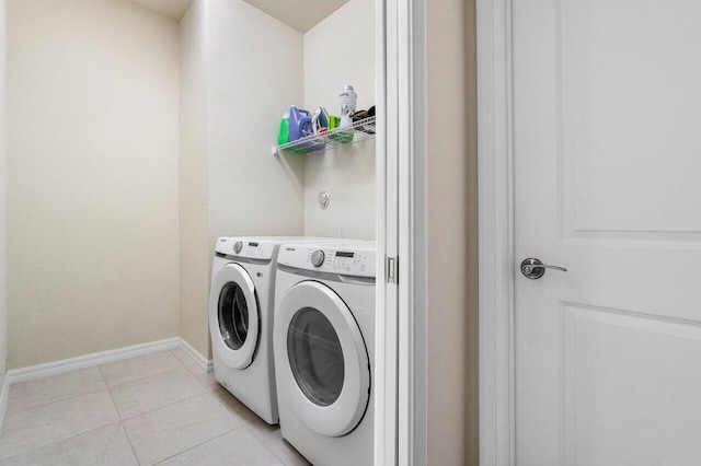 washroom with washer and dryer and light tile patterned floors