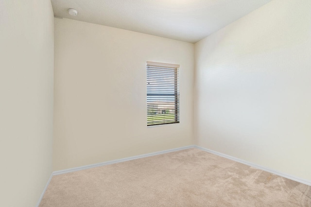 empty room featuring light carpet