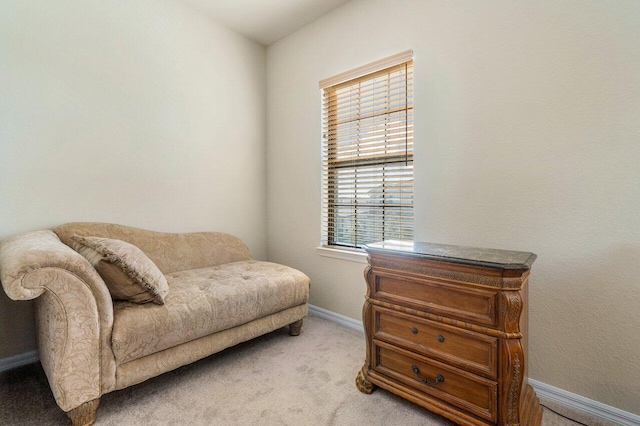 living area with a wealth of natural light and light colored carpet