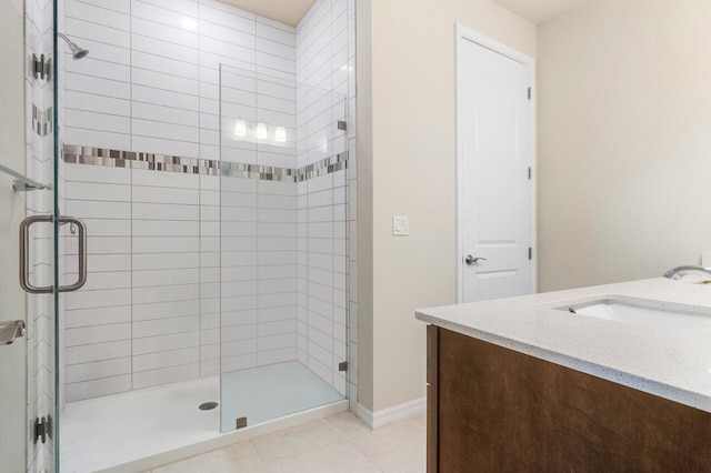 bathroom featuring vanity, walk in shower, and tile patterned flooring