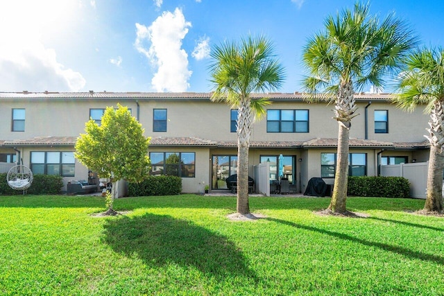 rear view of property featuring a yard