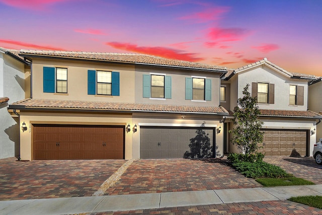 mediterranean / spanish home with a garage