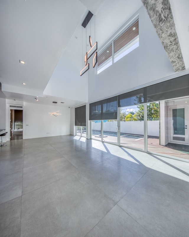 unfurnished living room with concrete flooring