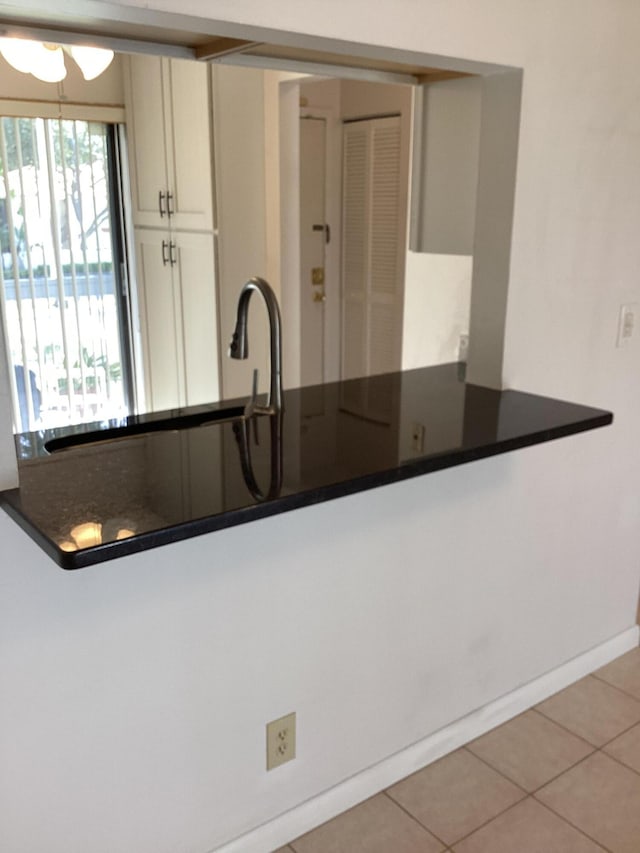 kitchen featuring white cabinets and light tile patterned floors