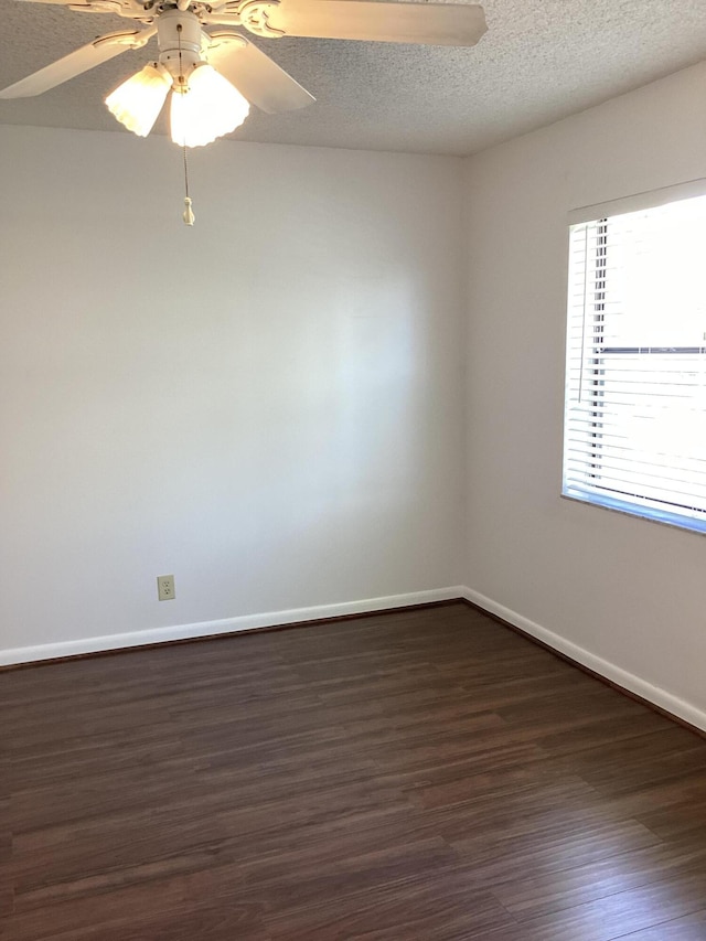 unfurnished room with a textured ceiling, dark hardwood / wood-style floors, and ceiling fan