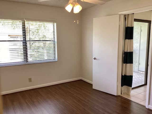 unfurnished room featuring hardwood / wood-style floors, ceiling fan, and a textured ceiling