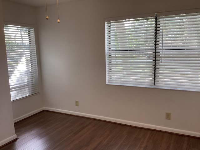 unfurnished room featuring dark hardwood / wood-style flooring