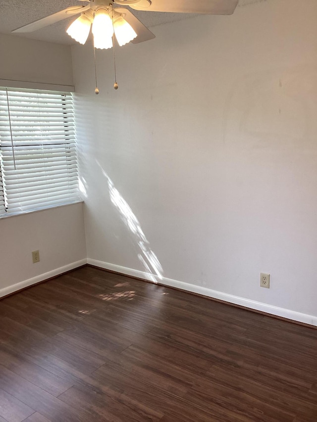 spare room featuring dark hardwood / wood-style floors and ceiling fan