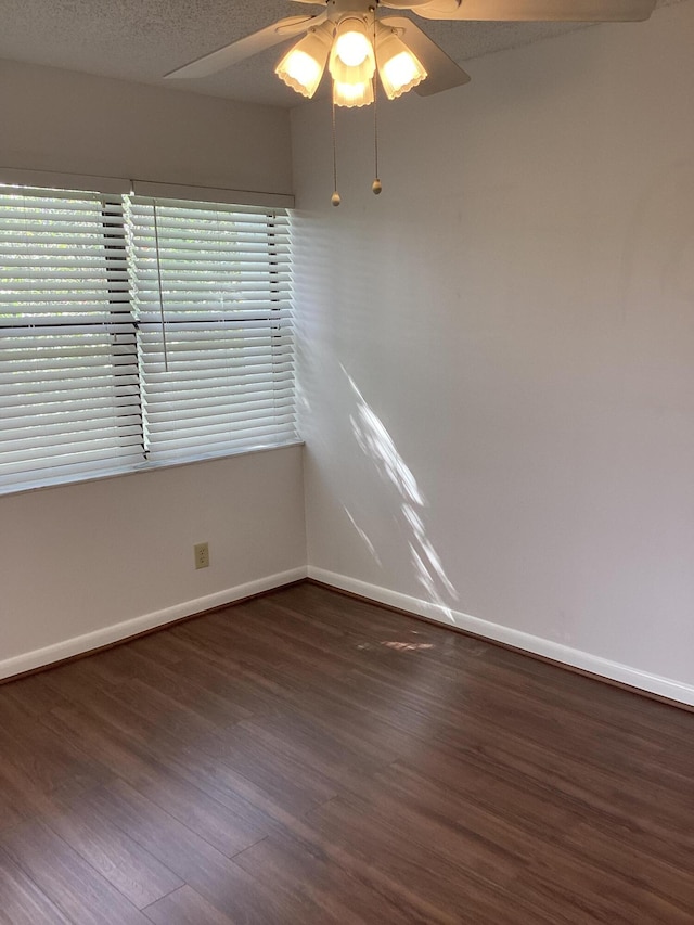 unfurnished room with dark wood-type flooring, ceiling fan, and a textured ceiling