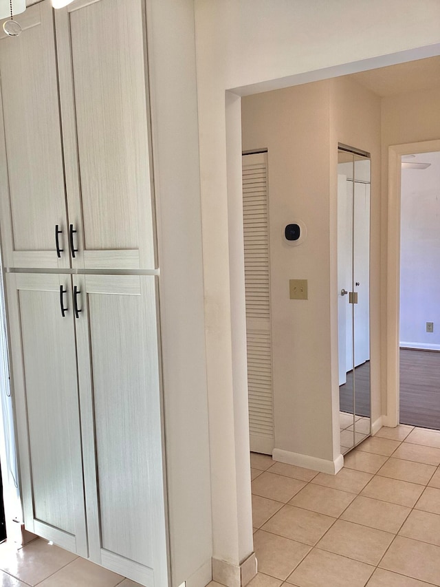 hall with light tile patterned floors