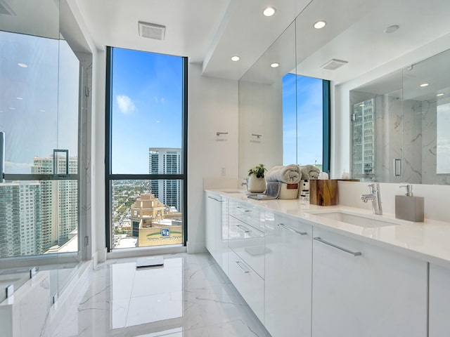 bathroom with a shower with door and vanity