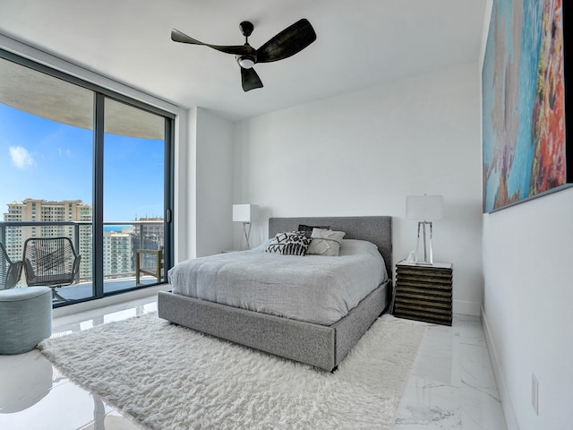 bedroom with access to outside, a wall of windows, and ceiling fan