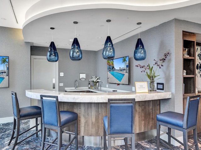 bar with sink and decorative light fixtures