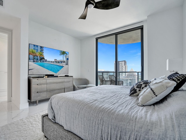 bedroom with ceiling fan and access to exterior