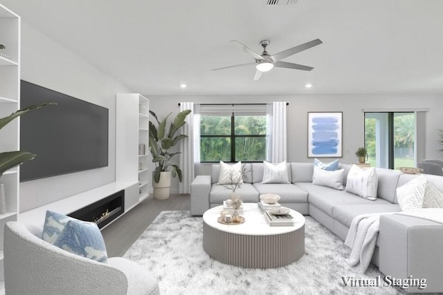 living room featuring ceiling fan and hardwood / wood-style floors