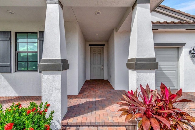 doorway to property with a garage