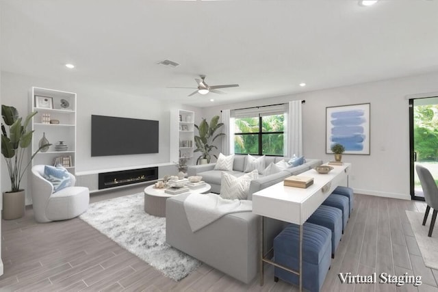 living room with ceiling fan, light hardwood / wood-style flooring, and built in features