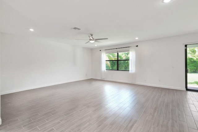 empty room with ceiling fan and light wood-type flooring