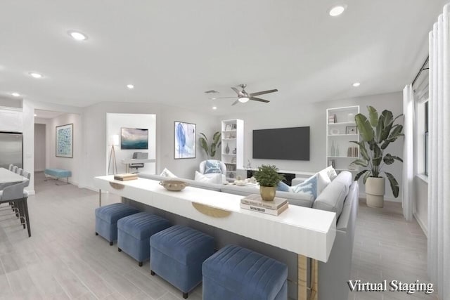 living room featuring ceiling fan and light wood-type flooring